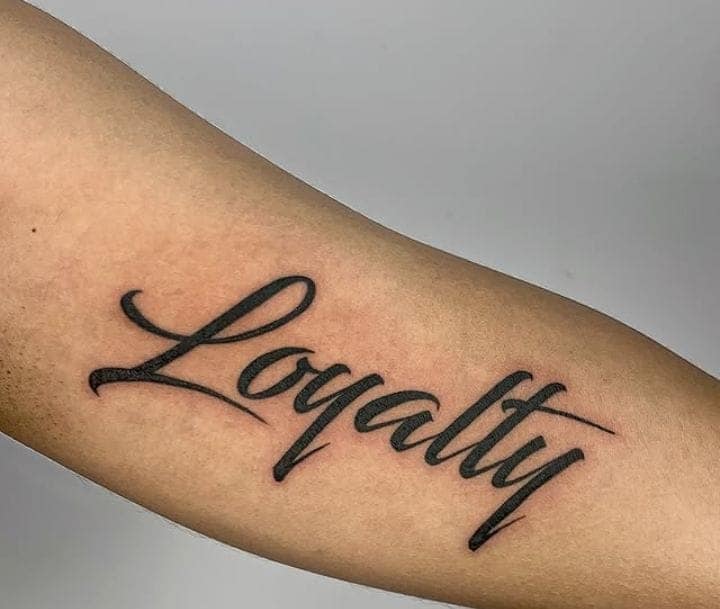 Classic Script Loyalty Inner Forearm Tattoo
