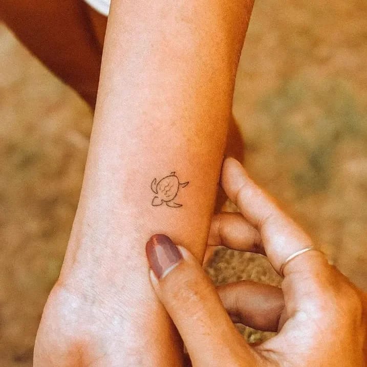 Delicate Wrist Turtle Design: Minimalist Outline with Deep Meaning