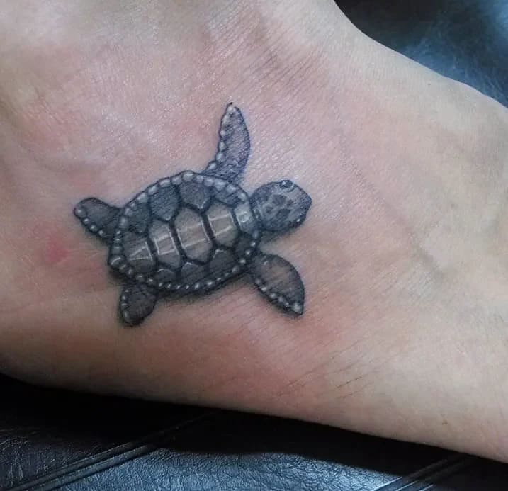 Realistic Foot Tattoo: Small Sea Turtle with Detailed Shading