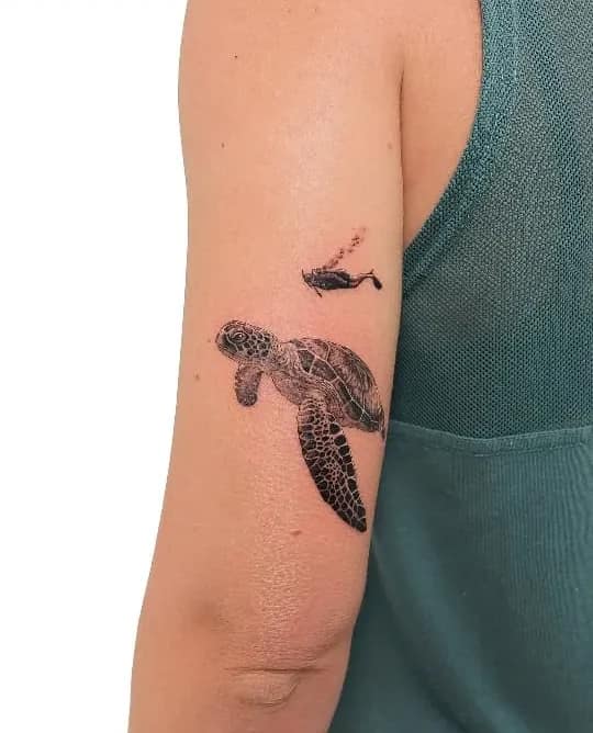 Realistic Swimming Turtle with Fish: Ocean Scene Arm Tattoo