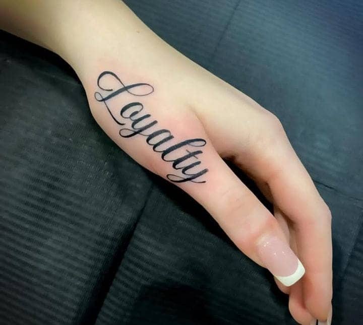 Simple Script Loyalty Finger Tattoo 